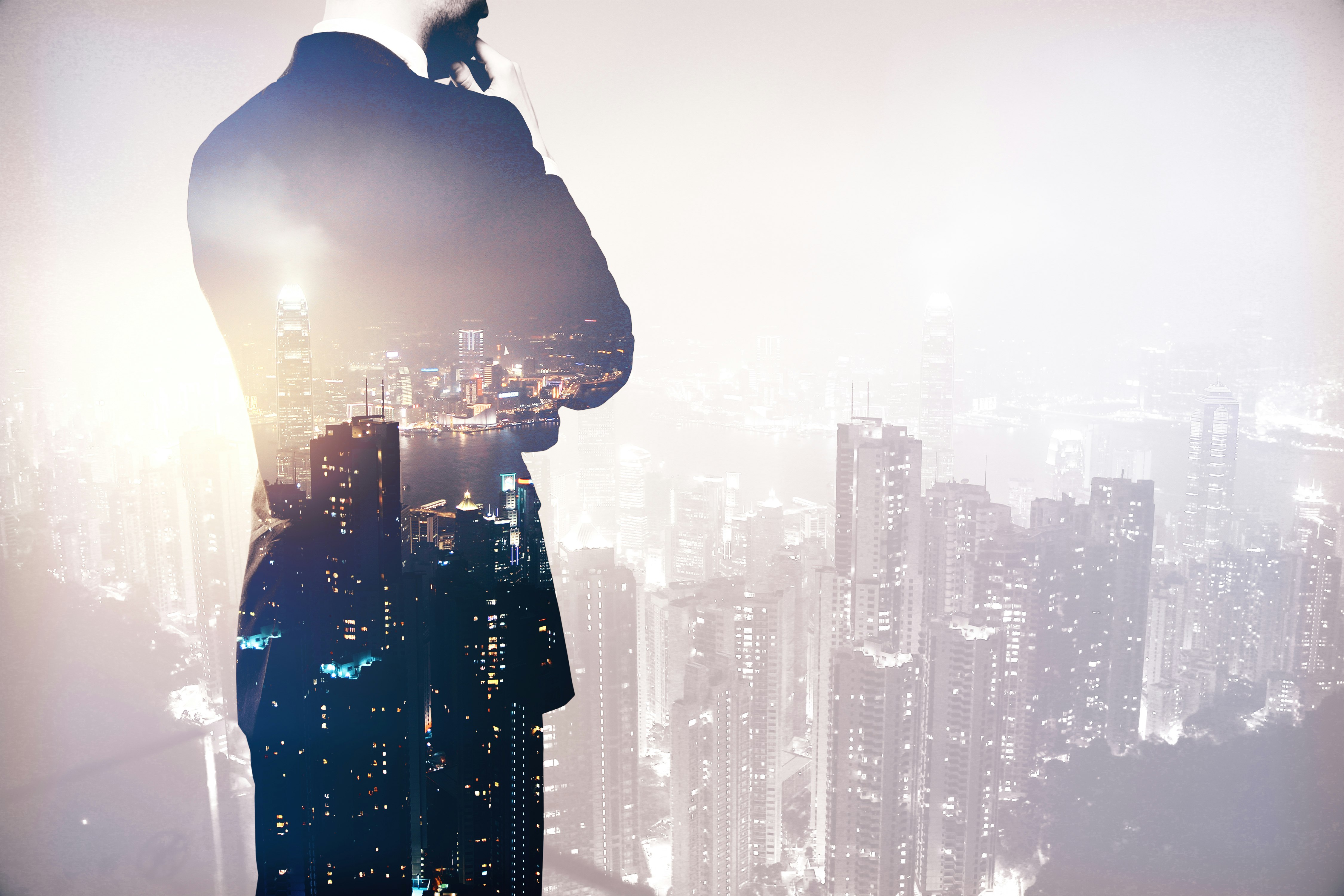 Back view of thinking business man in suit on night city background. Research concept. Double exposure